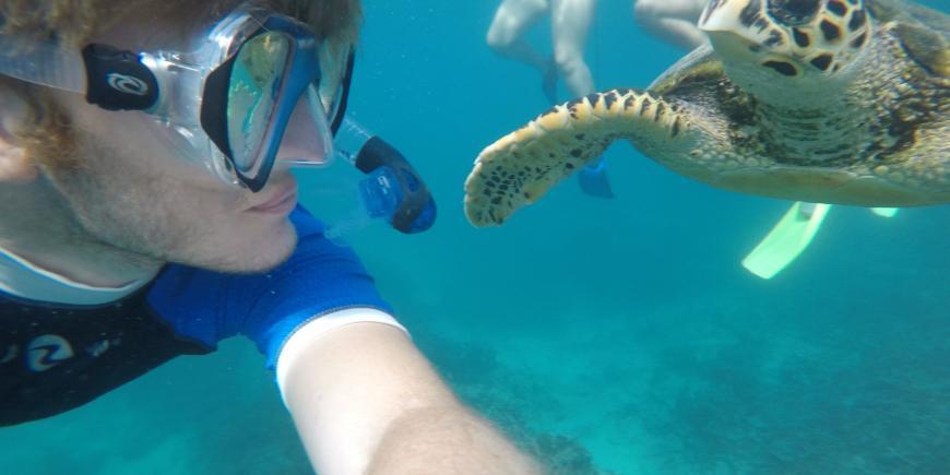 Intern Alex and hawksbill turtle in Mauritius