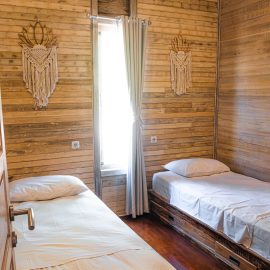 Volunteer bedroom with two twin beds and window