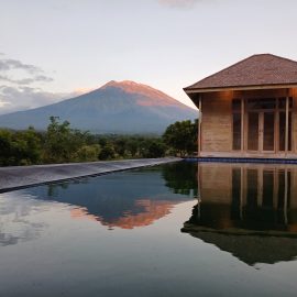 Lodge by pool with mountain view in background
