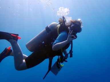 Volunteer diver giving okay sign
