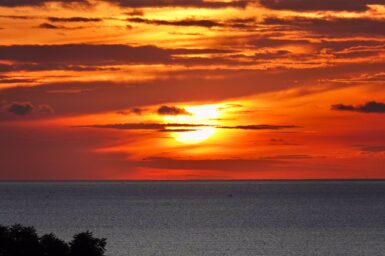 View of sun setting over the sea