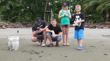 Children with sea turtles in Costa Rica