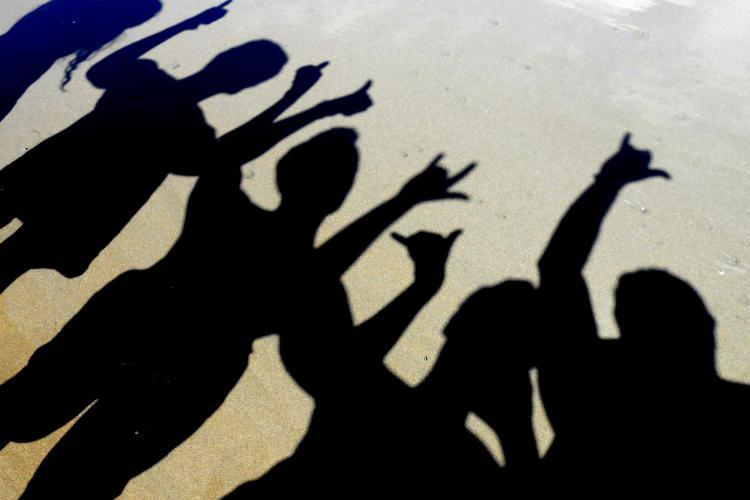 Shadow of volunteer group on the beach