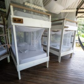 White bunkbeds standing next to each other on wooden platform