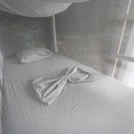 Made bed with linen folded as butterfly