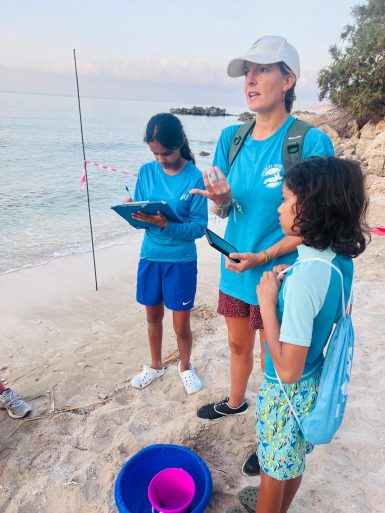 Young volunteers helping staff on beach