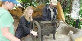 Volunteers grinding coffee in Ecuador forest