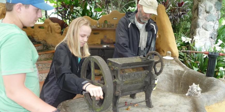 Volunteers grinding coffee in Ecuador forest