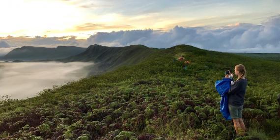 Volunteer taking photos on Galapagos coast