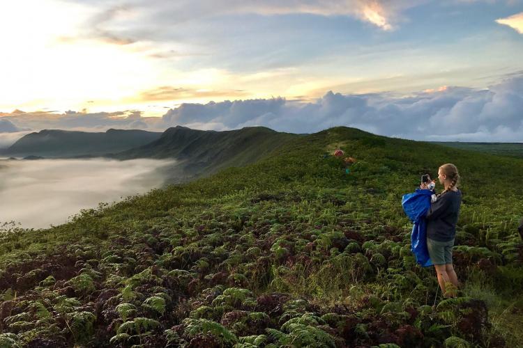 Volunteer taking photos on Galapagos coast