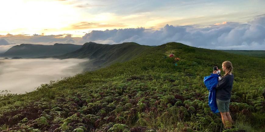 Volunteer taking photos on Galapagos coast