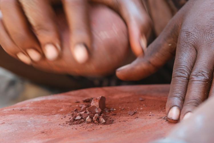 Hands by Himba red ochre in Namibia