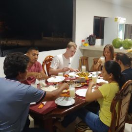 Volunteer eating with homestay family