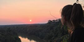 Volunteer enjoying sunset in amazon rainforest