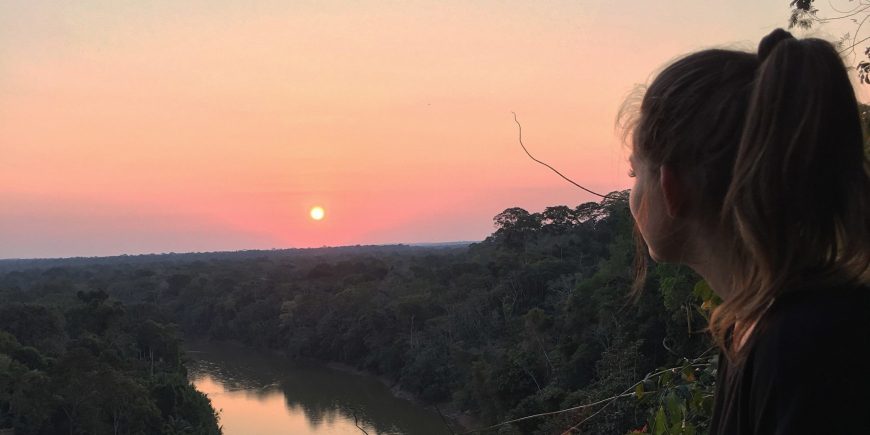 Volunteer enjoying sunset in amazon rainforest