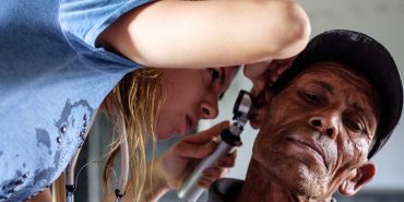 Medical volunteer giving hearing check in Nepal