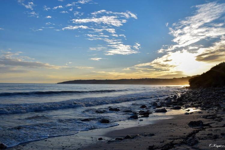 Volunteers watch sunset in Greece on Kefalonia coast