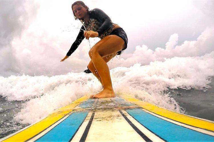 Woman surfing in Cabuya Costa Rica