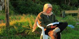Volunteer reading at nature reserve in New Zealand
