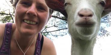 Volunteer with goat in Ecuador