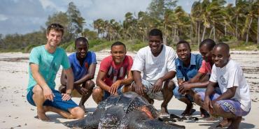Volunteers with sea turtle on the beach