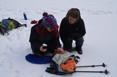 Wolf tracking volunteers reading map
