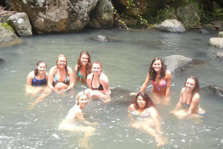 Volunteers swimming in waterfall Grenada
