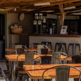 Tables with chairs around it and lodge bar area in the background