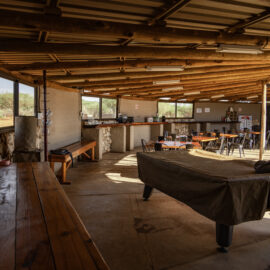 Lounge and breakfast area with a bit table in the middle and bamboo ceiling